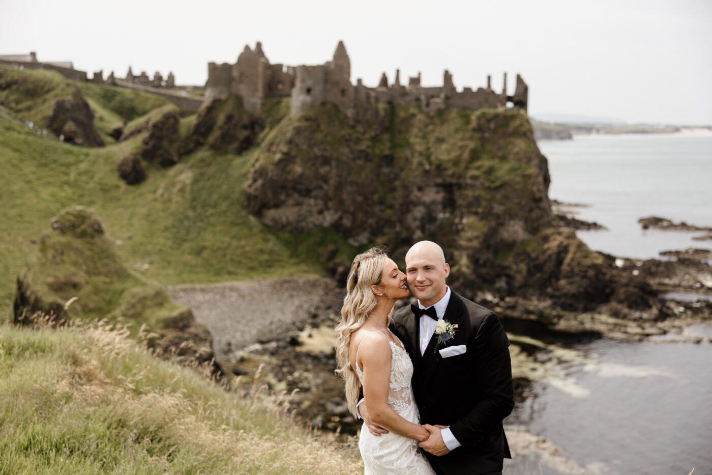 Northern Ireland elopement package couple with Dunluce Castle backdrop